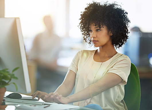 Woman in office working at computer